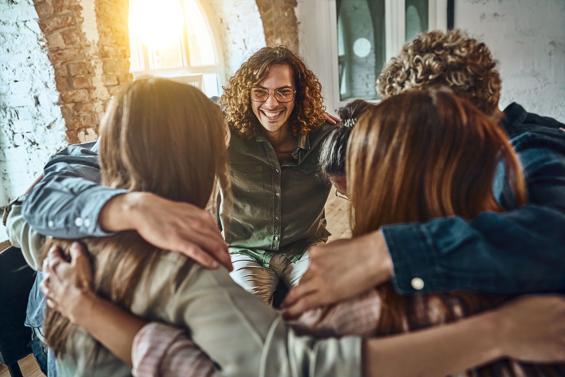 Circle of trust. Group of people sitting in circle and supporting each other.